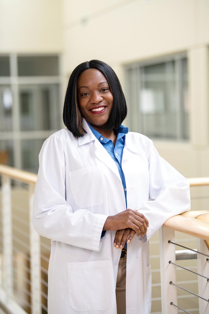 A woman posing in her white coat